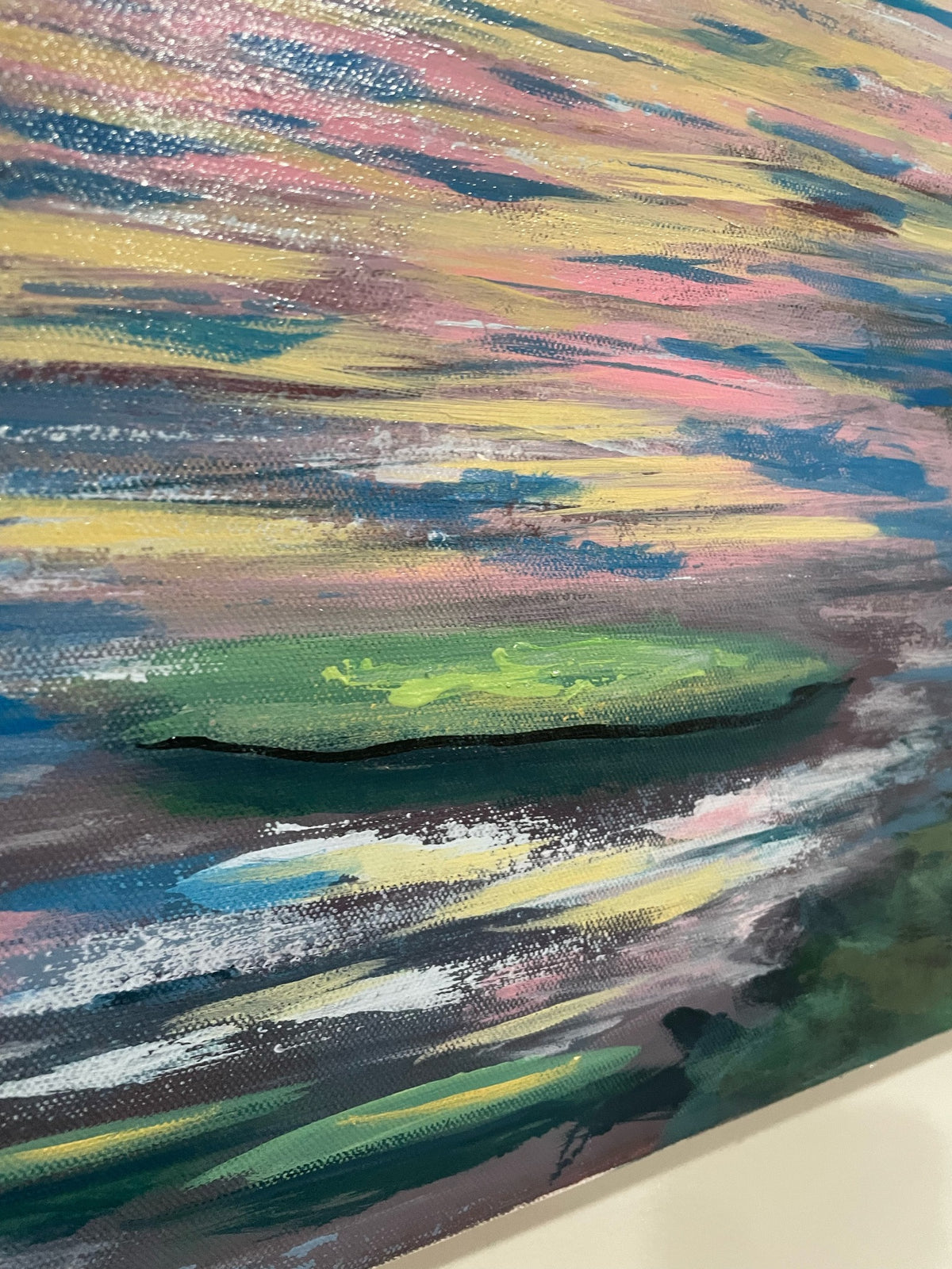 No One Likes Me original acrylic painting detail: angled view of a green lily pad on streaked pink, gold and blue water, showing canvas texture